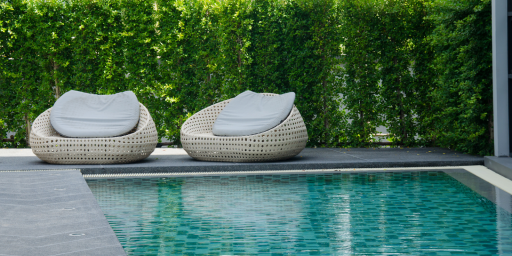 Well maintained commercial swimming pool with clean deck area, lounge seating, and balanced water managed by professional pool services.