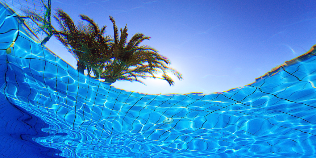 Underwater view of a clean swimming pool showing clear water, tiled pool surface, and proper pool maintenance standards.